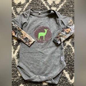 Long sleeved onesie with camo sleeves and green deer